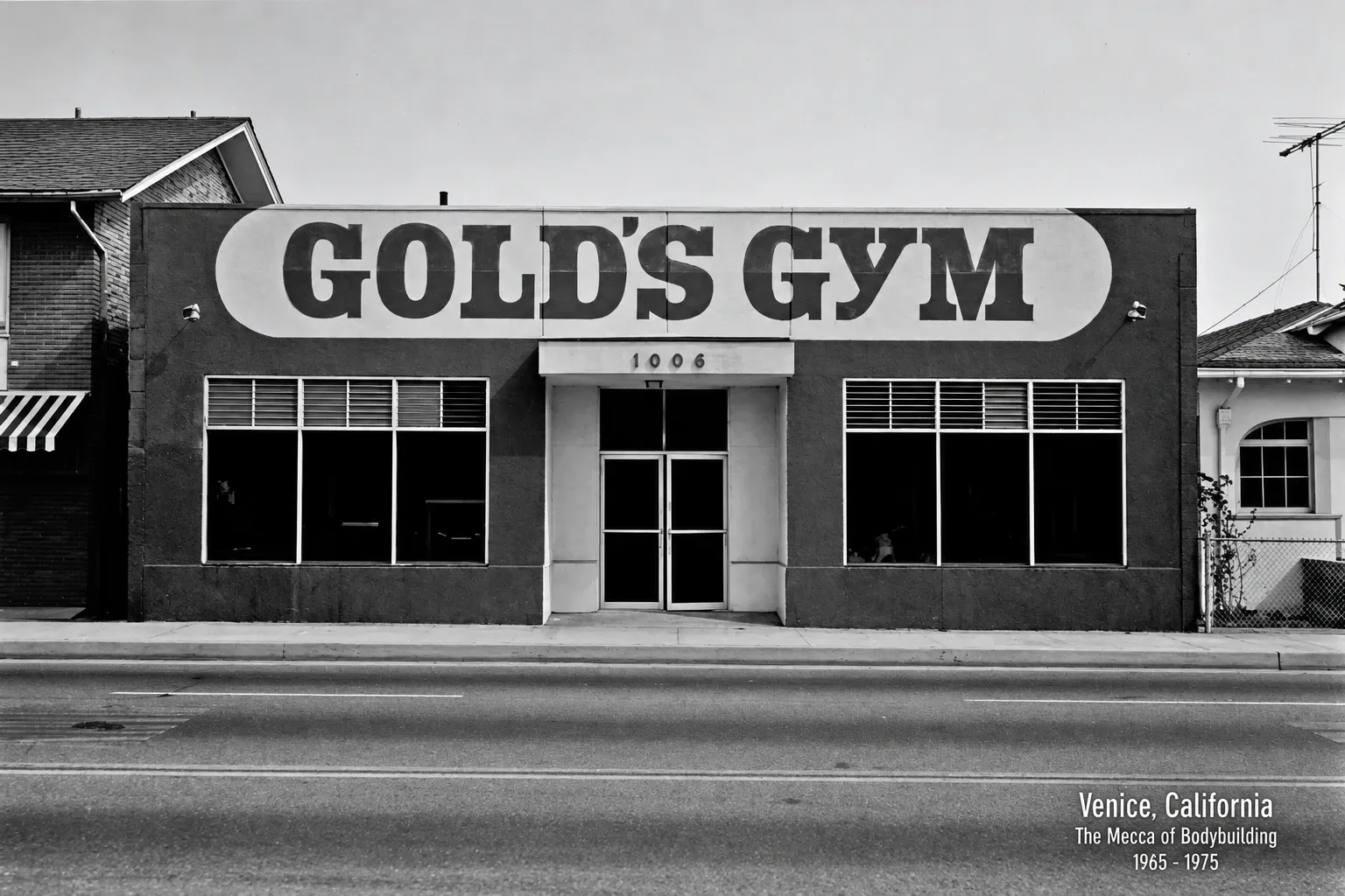 Black and white photo of the original Gold's Gym in Venice, California: a low building with the Gold's Gym sign above the door. The photo's caption reads Venice, California, The Mecca of Bodybuilding, 1965 to 1975.